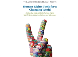 [ai] A hand raised in a peace sign, covered with colorful flags from various countries. Above the hand is the text, 'Human Rights Tools for a Changing World,' along with a subtitle about a guide to human rights.